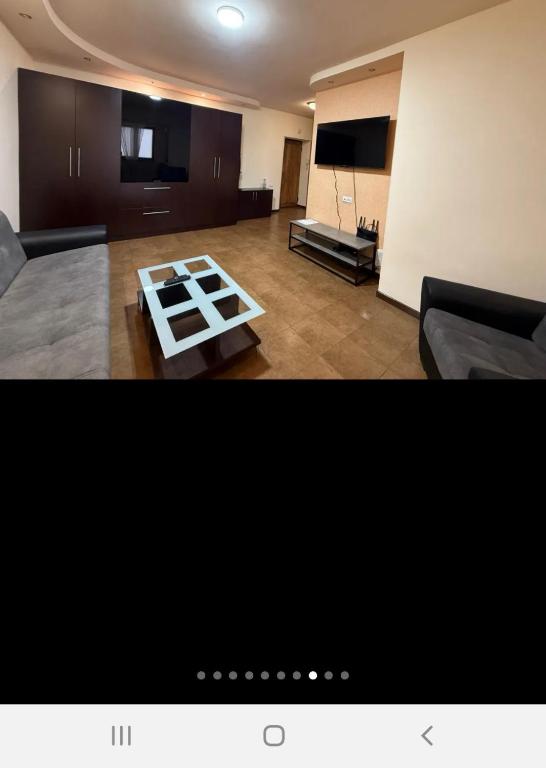 a living room with a couch and a table at Квартира in Aghk'ilisa
