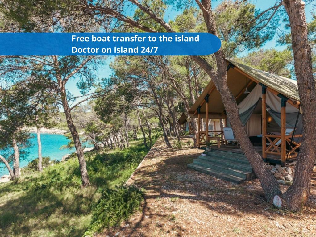 a cabin in the woods next to the ocean at Obonjan Island Resort in Šibenik