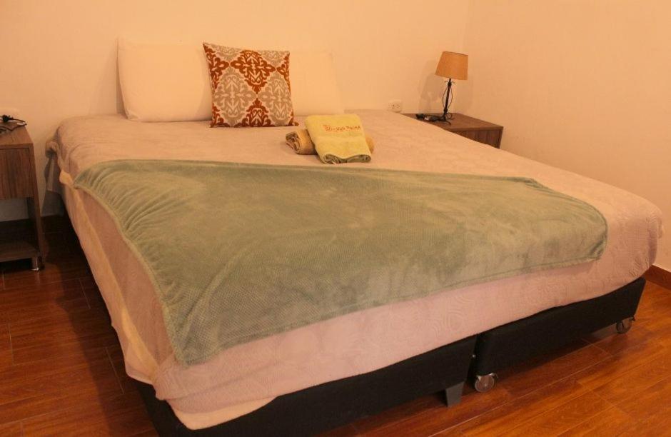 a large bed with two pillows on top of it at Kay Pacha Wellness Place Eco in Ayacucho