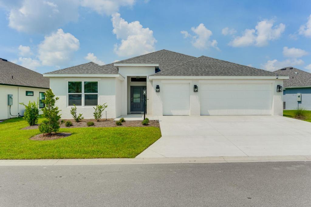 a large white house with a driveway at New Designer Home in The Villages Shady Brook in Wildwood