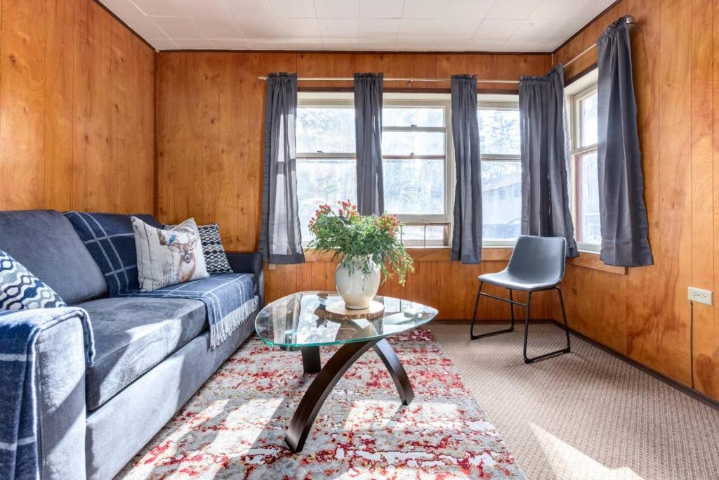 a living room with a couch and a table at Huckleberry Lodge Mountain Getaway Near Banff in Canmore