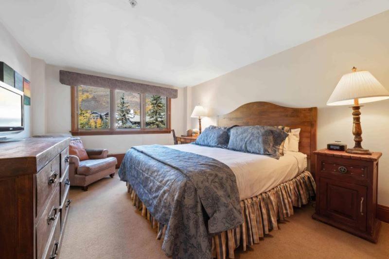 a bedroom with a large bed and a television at Lodge Tower 290 in Vail