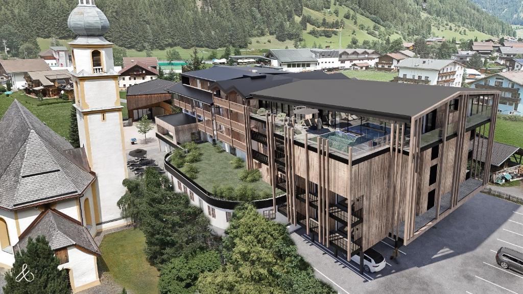 eine Luftansicht eines Gebäudes mit einem Turm in der Unterkunft Hotel Kirchenwirt in Kaunertal