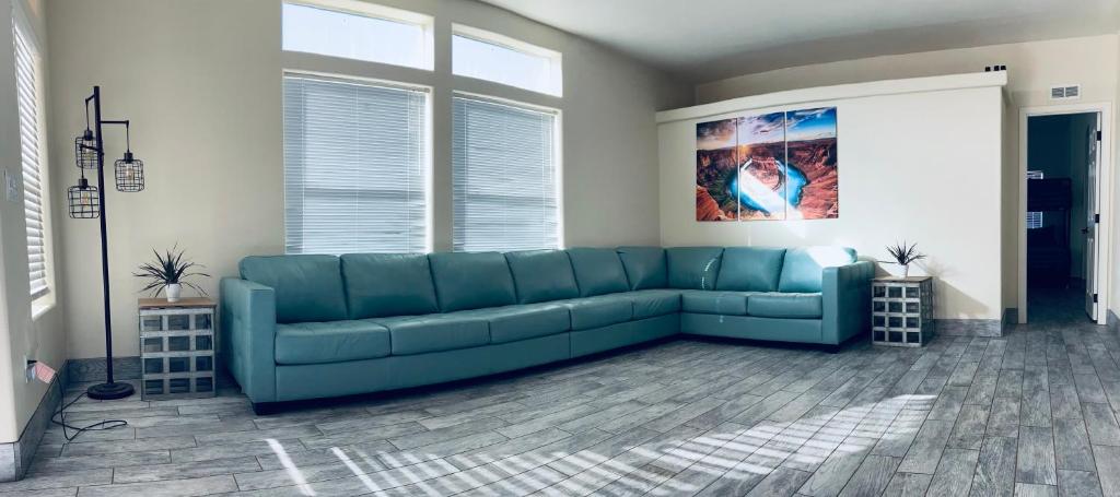 a living room with a blue couch in a room at ️Full Kitchen11 bedbath in this home at discountnear canyonsBoat Parking in Page