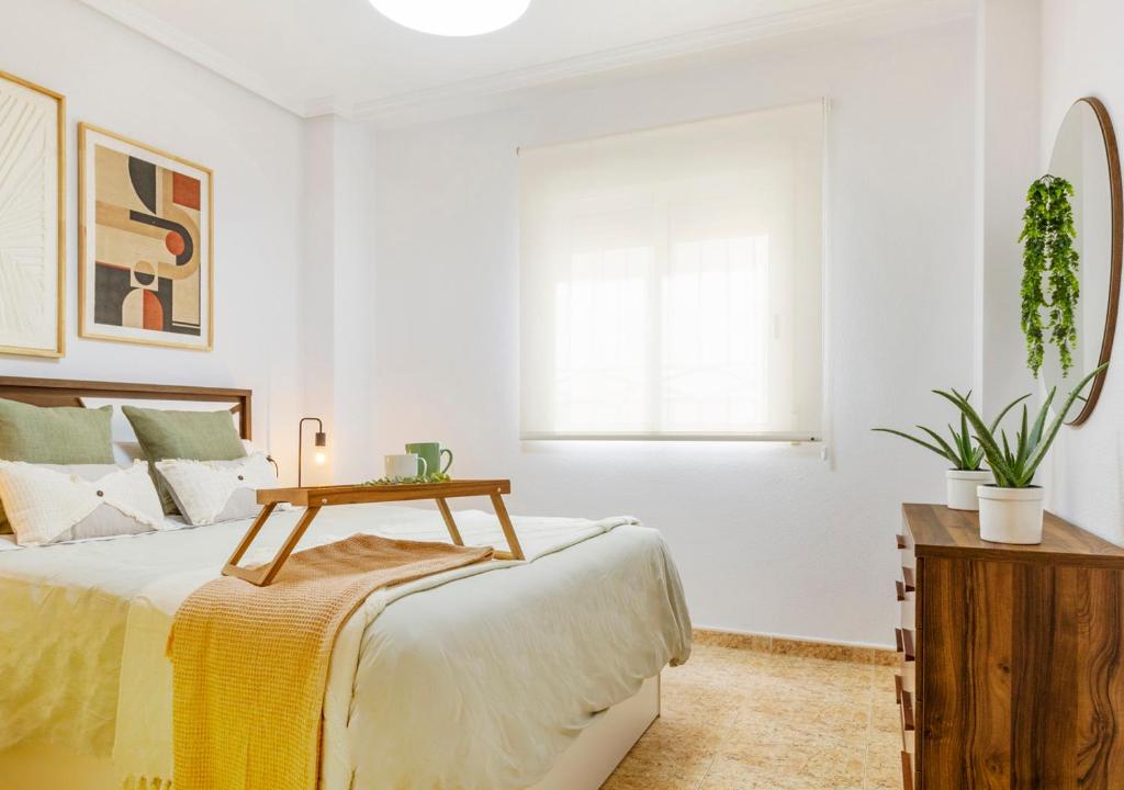 a bedroom with a bed with a table on it at Dream Costa Blanca Luxury Apartment in Torrevieja