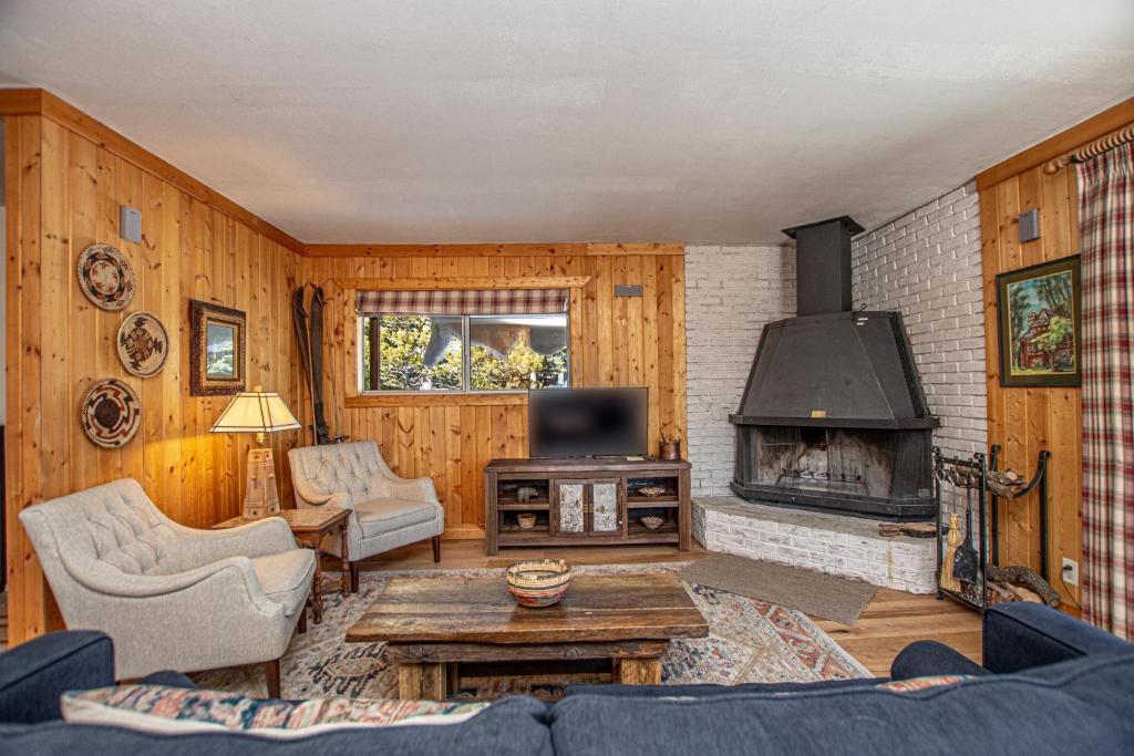 a living room with a couch and a fireplace at Goetzl By Hauserman Rentals in Tahoma