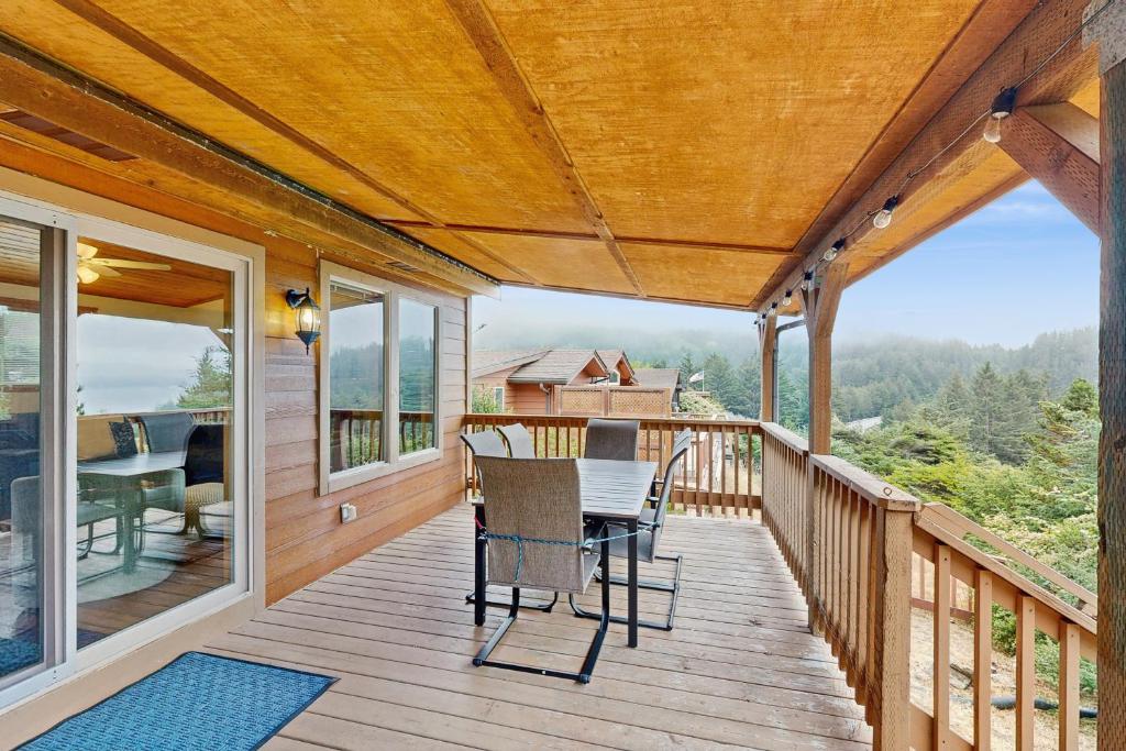 a wooden deck with a table and chairs on it at Whaleshead Getaway in Carpenterville