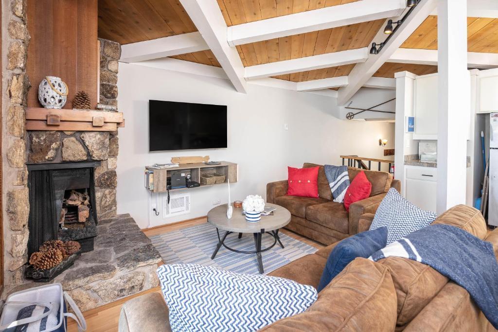 a living room with a couch and a fireplace at Star Harbor # 10 By Hauserman Rentals in Tahoe City