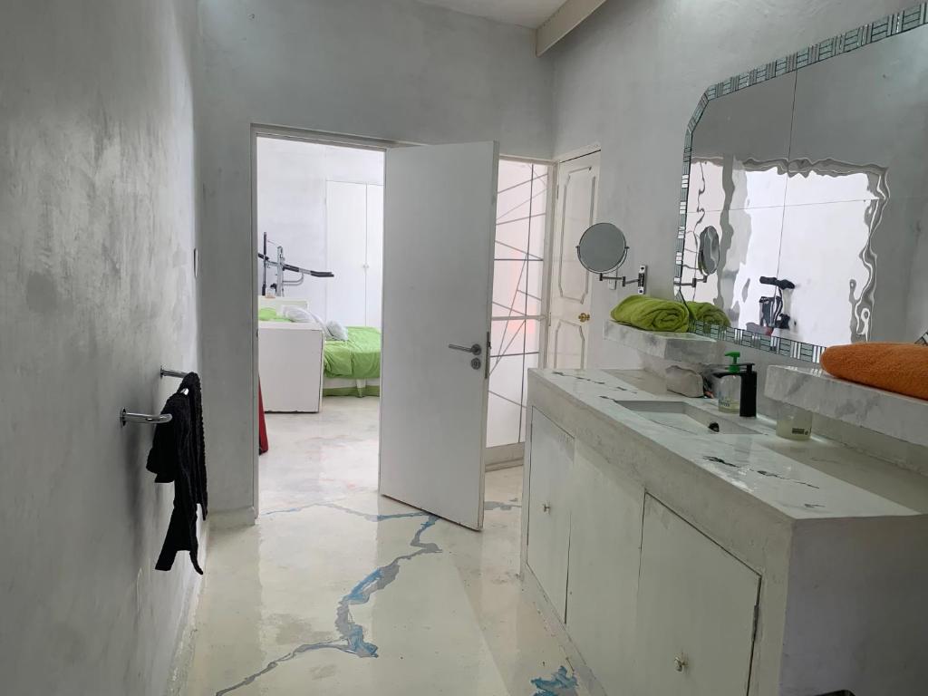 a white bathroom with a sink and a mirror at Casa sola con alberca y vista al lago in Cedro