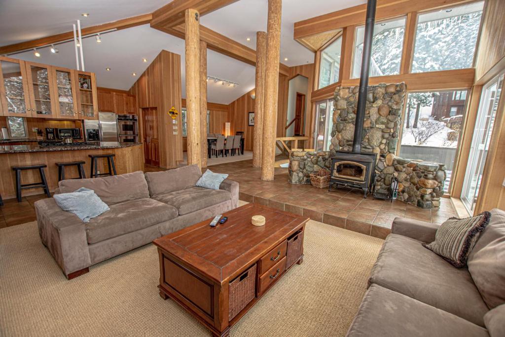 a living room with a couch and a fireplace at Snow Crest By Hauserman Rentals in Alpine Meadows