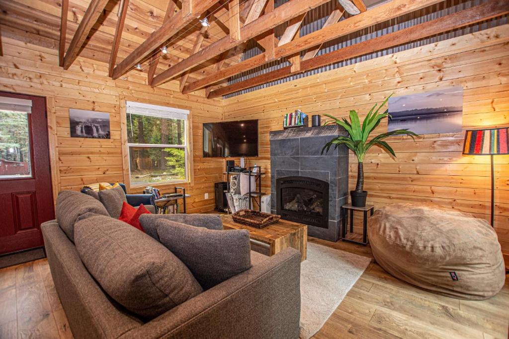 a living room with a couch and a fireplace at O'Brien's Den By Hauserman Rentals in Tahoma