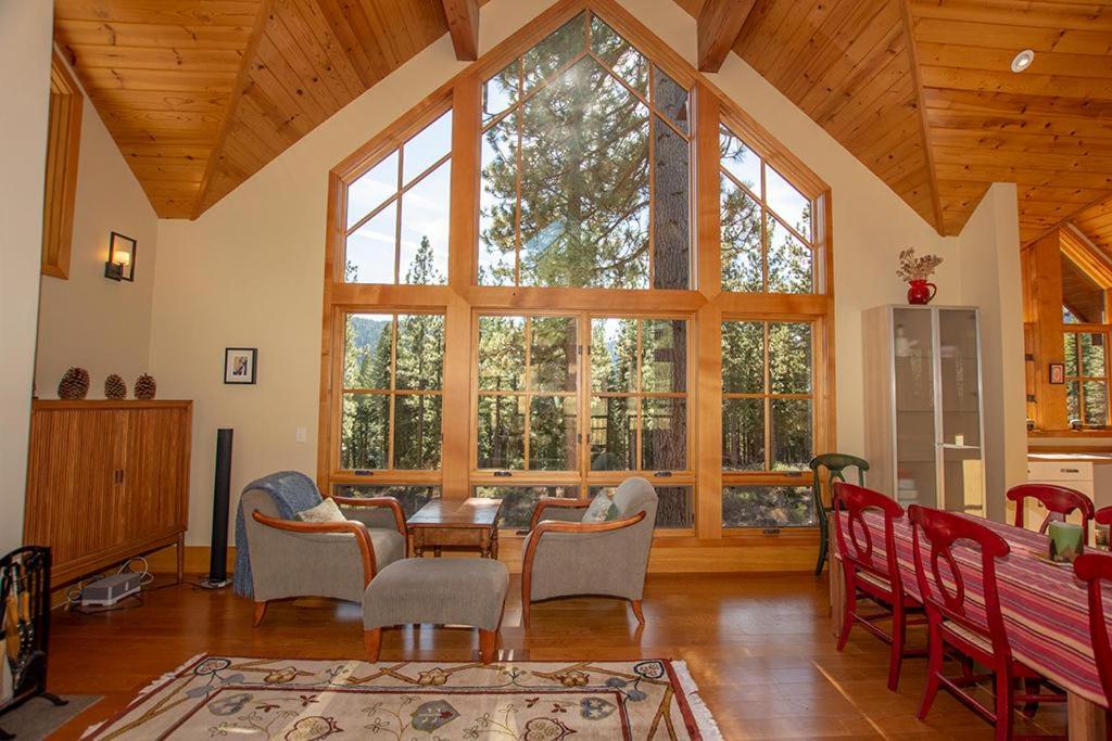 a living room with a table and chairs and a large window at Snowglobe By Hauserman Rentals in Tahoe City