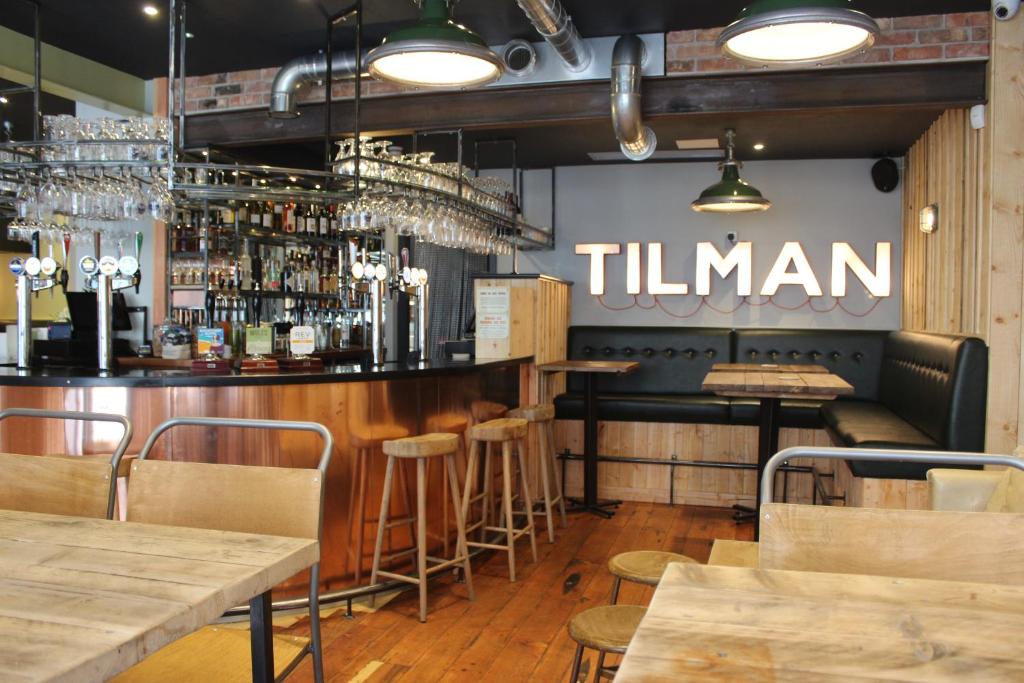 a bar in a restaurant with a sign that reads titan at The Tilman in Barmouth