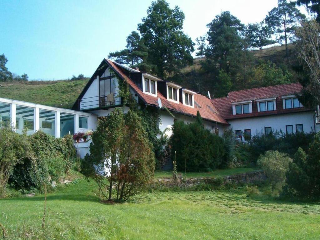 a house on top of a hill with a yard at Private Pool & Terrace Stay in Bechyně