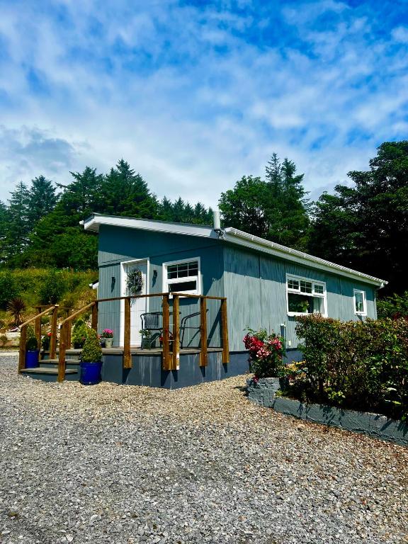 a blue tiny house sitting on top of gravel at Rose Cottage in Killybegs