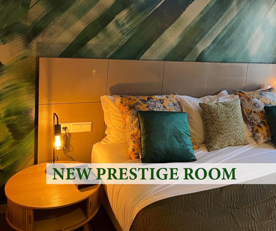 a new prestige room with a bed with colorful pillows at BE ONE HOTEL Caldas da Rainha - by MHMB Hospitality in Caldas da Rainha