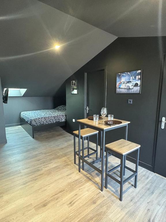 a room with a table and chairs and a bed at racing room in Bressuire