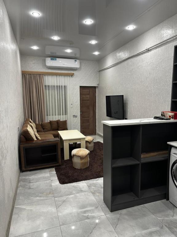 a living room with a couch and a tv in a room at Gasparyan's Guest House in Pʼarakʼar