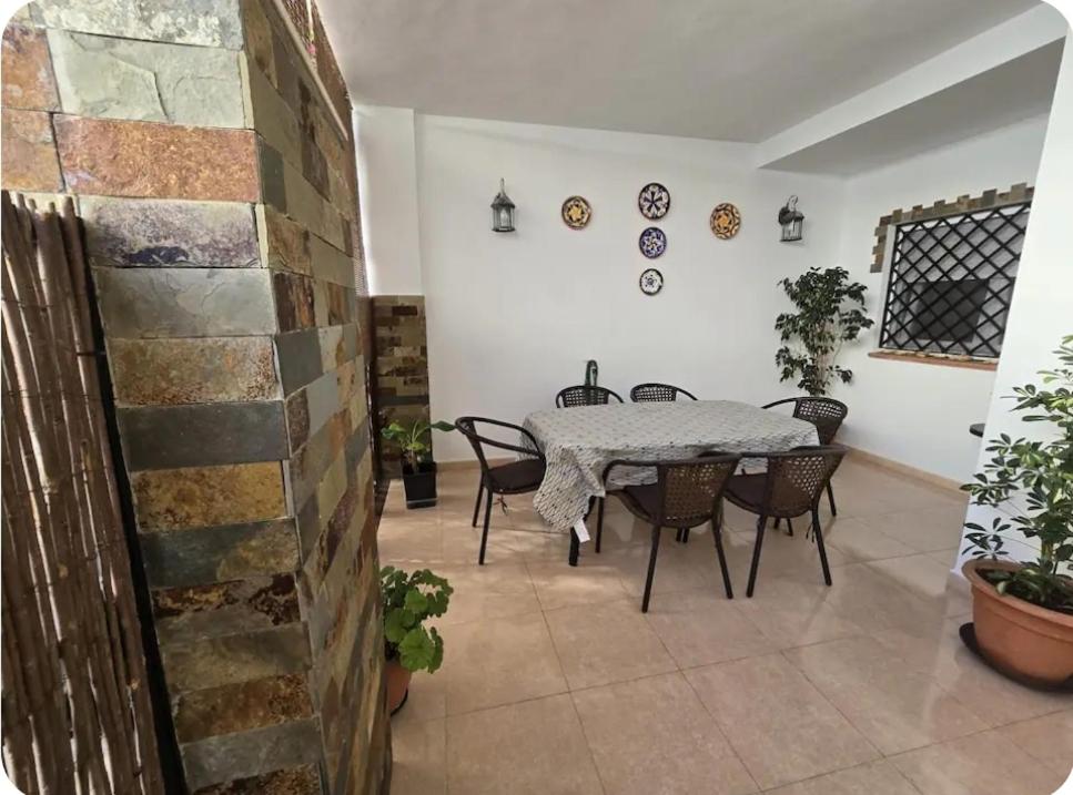 a dining room with a table and chairs at Céntrico adosado cerca de la playa in Punta Umbría