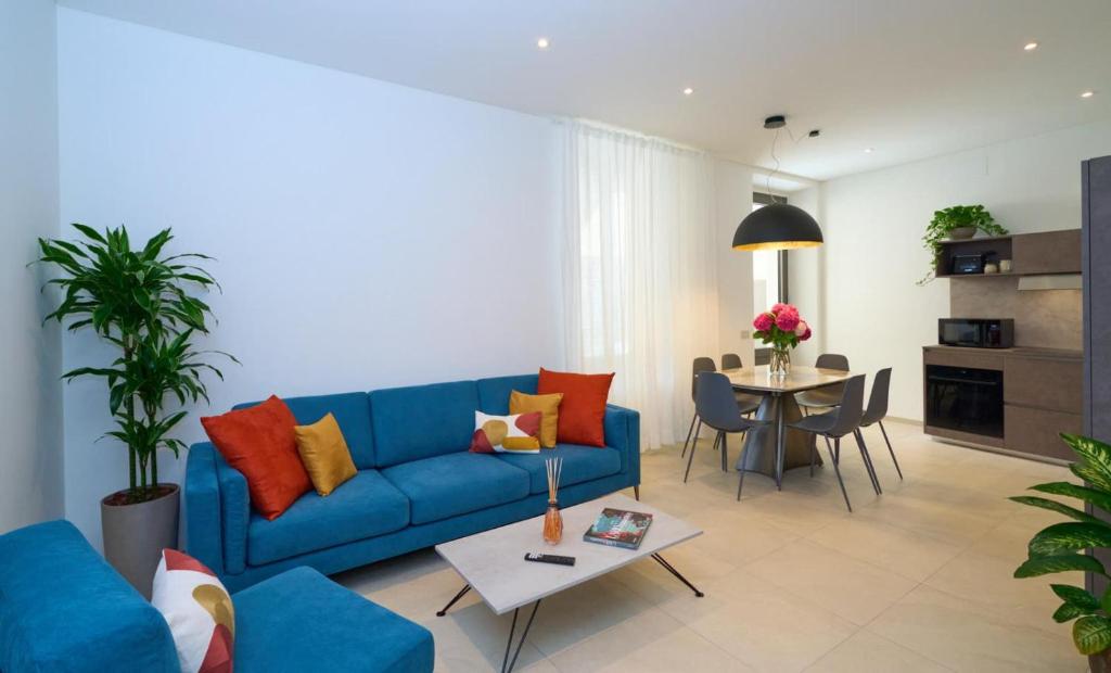 a living room with a blue couch and a table at Casa Leo in Argegno