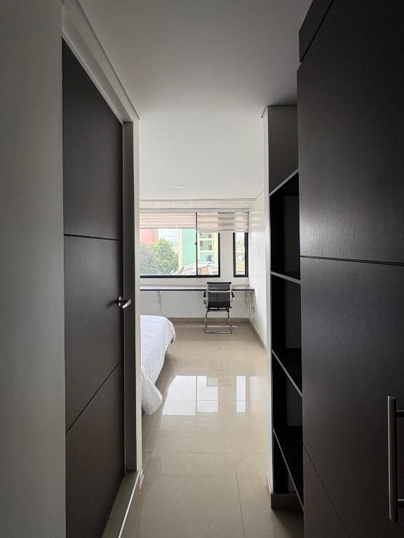a room with a bed and a room with a window at Casa Seganis in Bogotá