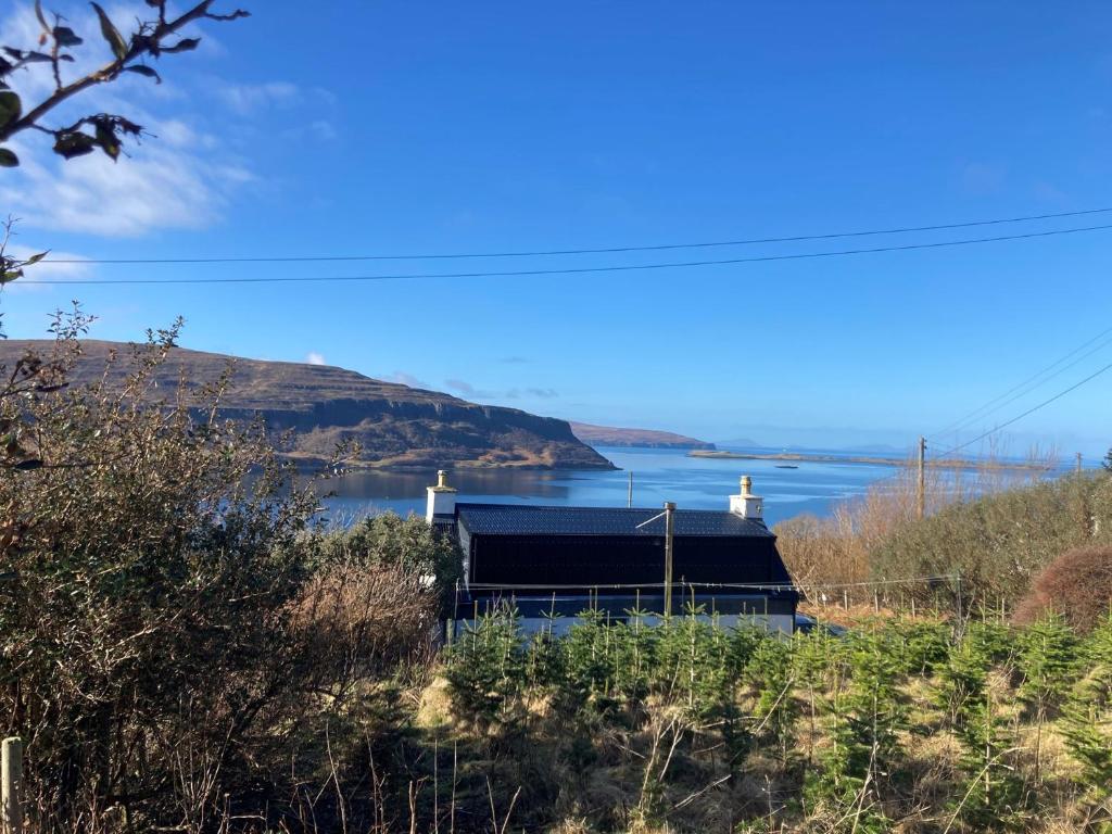 a house with a view of a body of water at 3 Bed in Waternish 93005 in Stein
