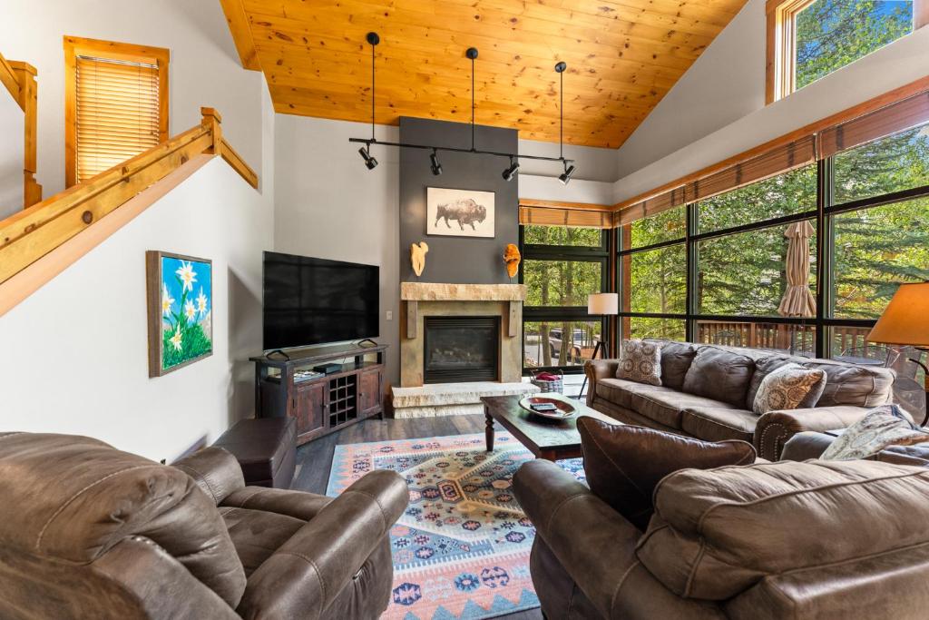 a living room with leather furniture and a fireplace at Ski Tip 8709 by Summit County Mountain Retreats in Keystone