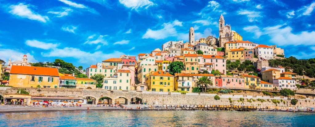 a group of buildings on a hill next to a body of water at Romantic room nel Borgo di Cervo in Cervo