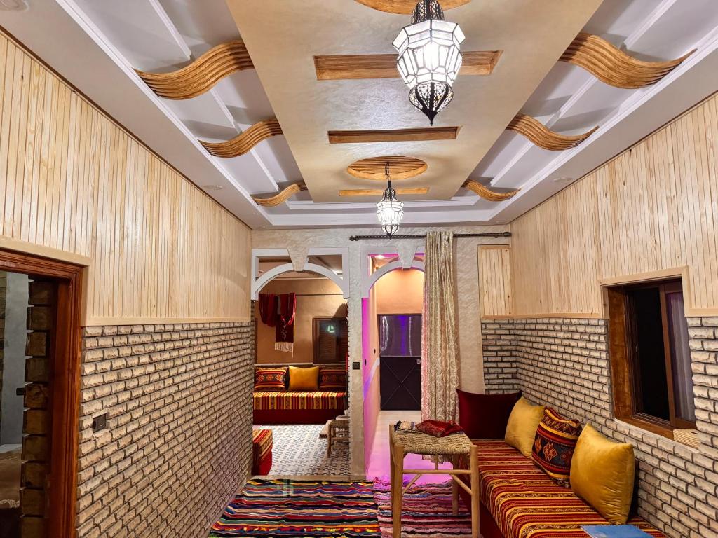 a living room with a couch and a ceiling at Toubkal home stay in Imlil