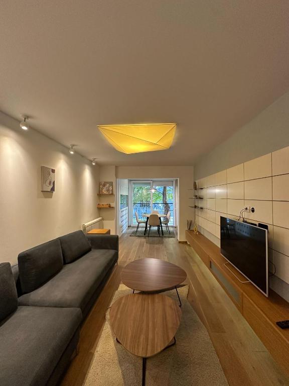 a living room with a couch and a table at Venus Luxury Apartment in Skopje
