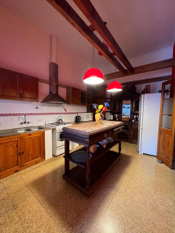 a kitchen with a table and a white refrigerator at Casa Rocamora - Victoria Entre Ríos in Victoria