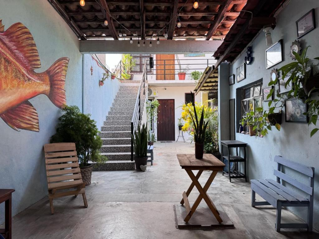 a hallway with benches and stairs in a building at Casa Rockot in Puerto Escondido
