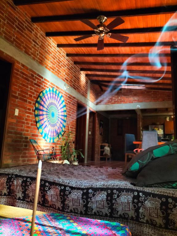 a room with a bed and a brick wall at Habitación privada in Santa Marta