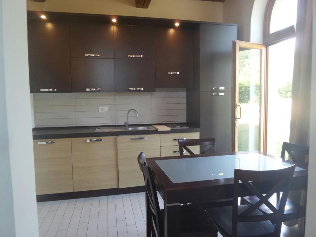 a kitchen with a table and a sink and cabinets at Cala Dei Mori in Livorno