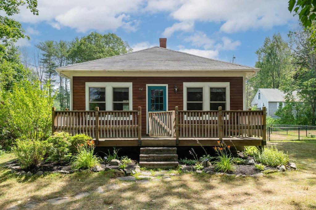 a small house with a porch and a deck at Maine Coastal Cottage in Wells