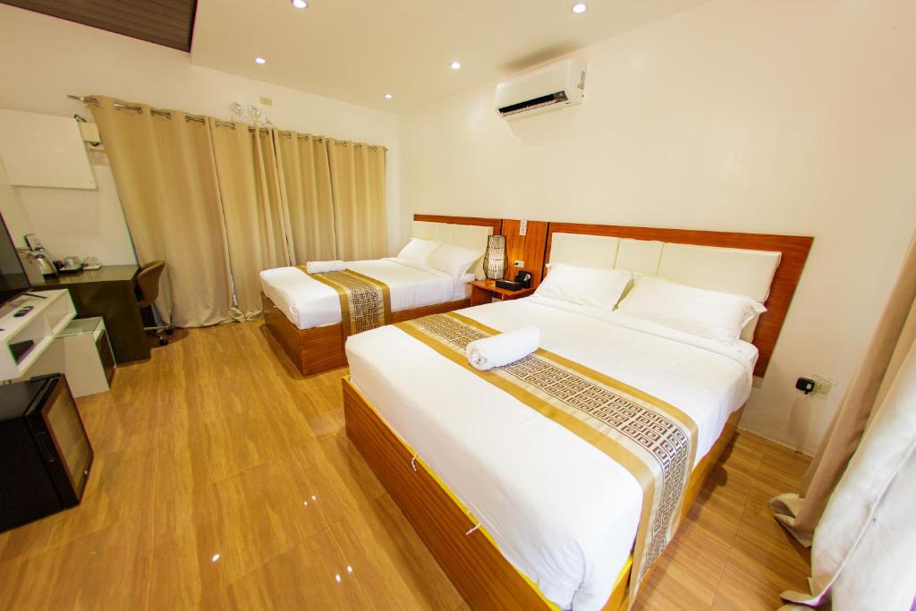 Postel nebo postele na pokoji v ubytování Brittannika Golf Course Incorporated