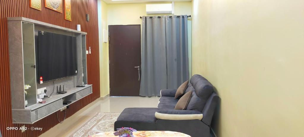a living room with a couch and a tv at Putera homestay in Juasseh