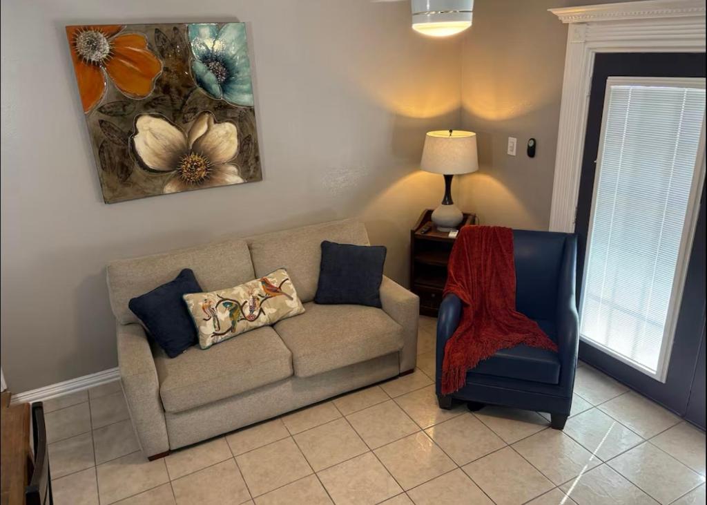 a living room with a couch and a chair at 1 BR 1 Bath Airport SpaceX LNG WashDry Yard Patio Pets in Brownsville