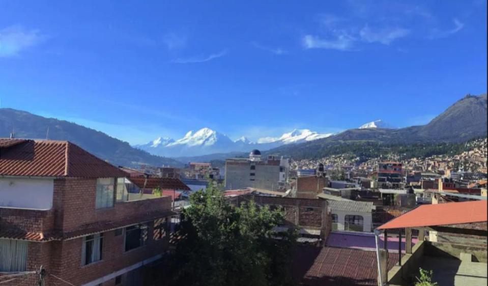 a city with snow capped mountains in the background at Huaraz chill spot Private room Shared bathroom Cerca del Centro in Huaraz