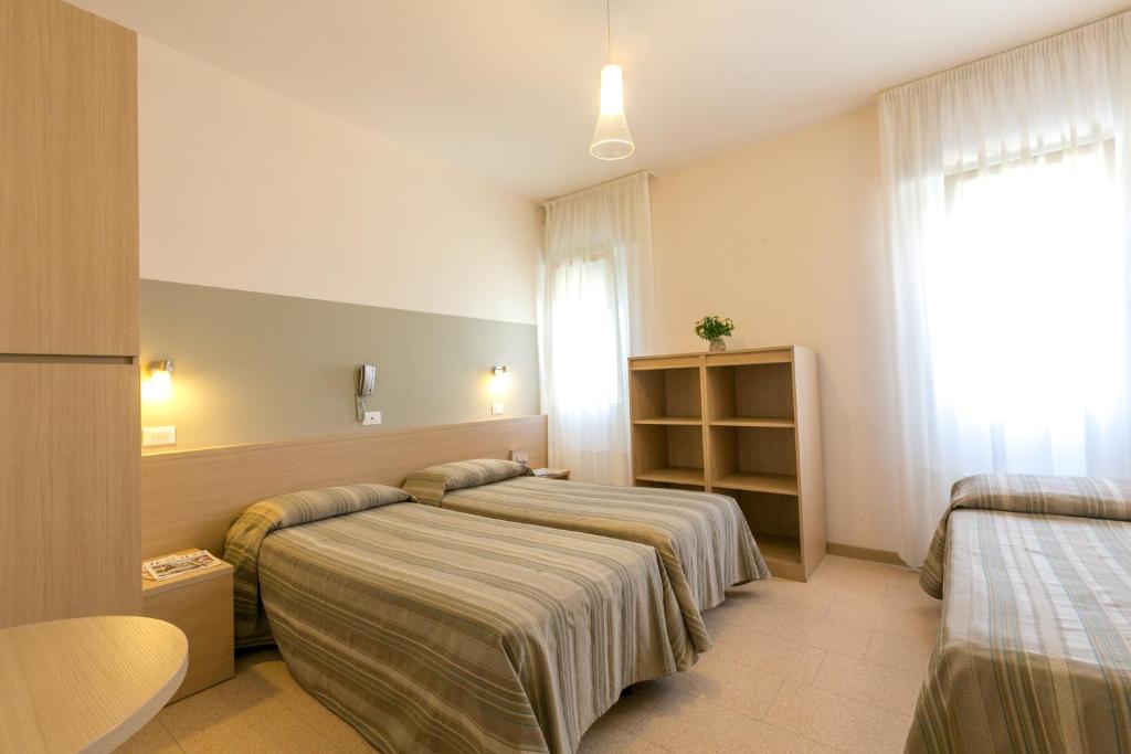 Postel nebo postele na pokoji v ubytování Hotel Colonna