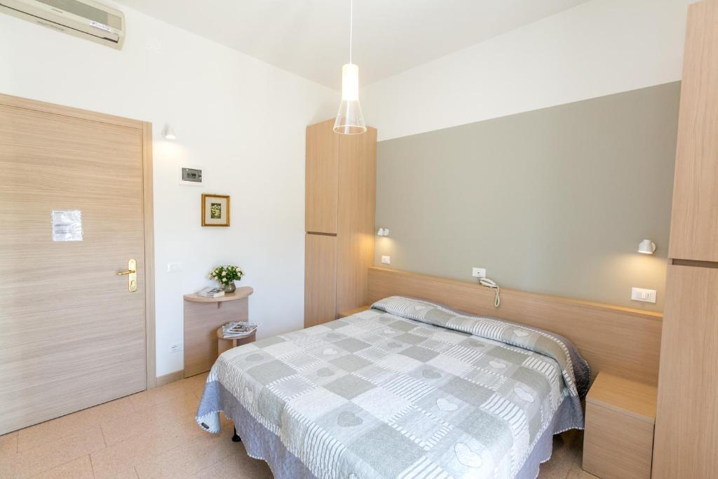 Postel nebo postele na pokoji v ubytování Hotel Colonna