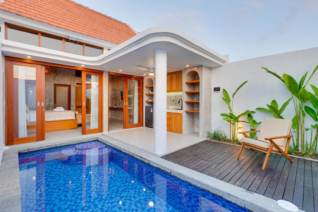 a villa with a swimming pool and a bedroom at Charming 1BR Villa Gypsophila Laluxe A16 Sanur in Sanur
