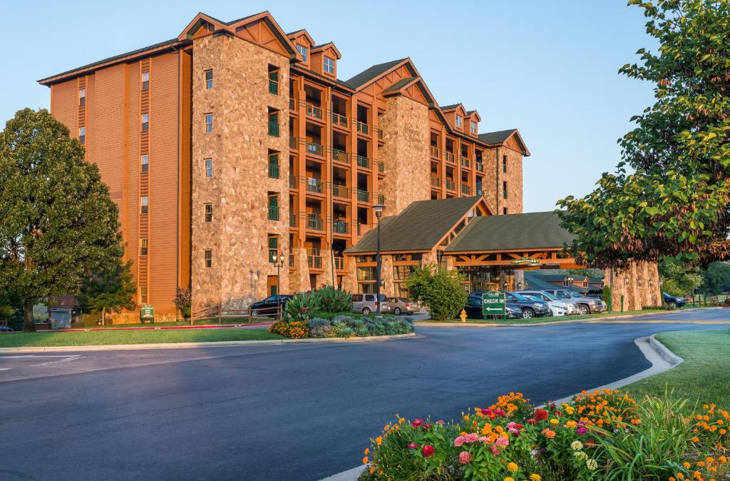 a large brick building with cars parked in a parking lot at Westgate Branson Woods Resort in Branson
