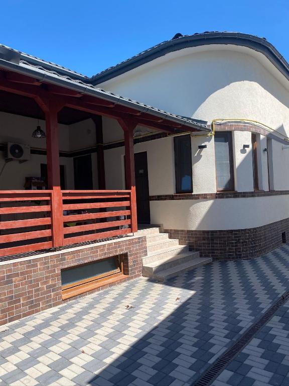 a building with a porch and stairs on it at Apartamentele Liliacul in Sighetu Marmaţiei
