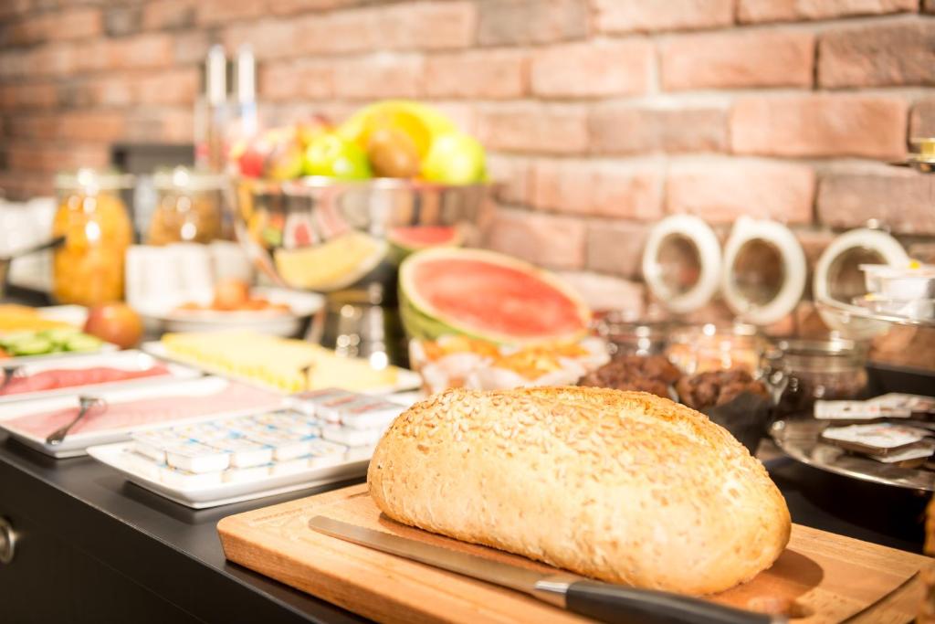 a loaf of bread on a cutting board on a counter at Citiez Hotel Amsterdam in Amsterdam
