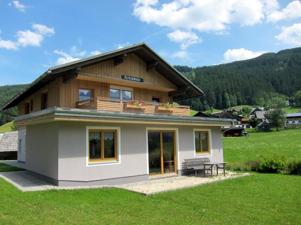 a small house with a balcony on top of it at Apartment Urstöger in Gosau