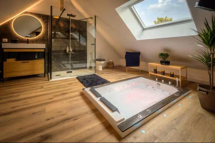 a large bathroom with a tub in the middle of a room at Lovely Bleau in Perthes-en-Gâtinais