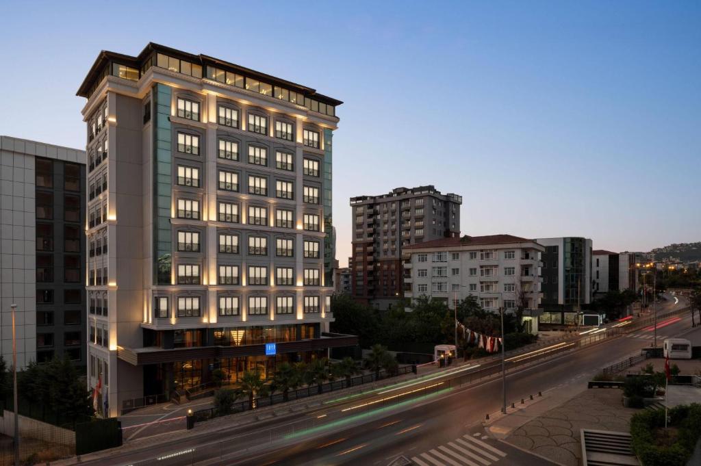 a tall building on a city street with buildings at TRYP by Wyndham Istanbul Maltepe in Istanbul