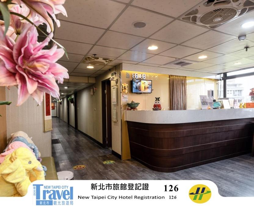 una hall di un ospedale con un fiore rosa sul muro di Sofu Hotel a Taipei