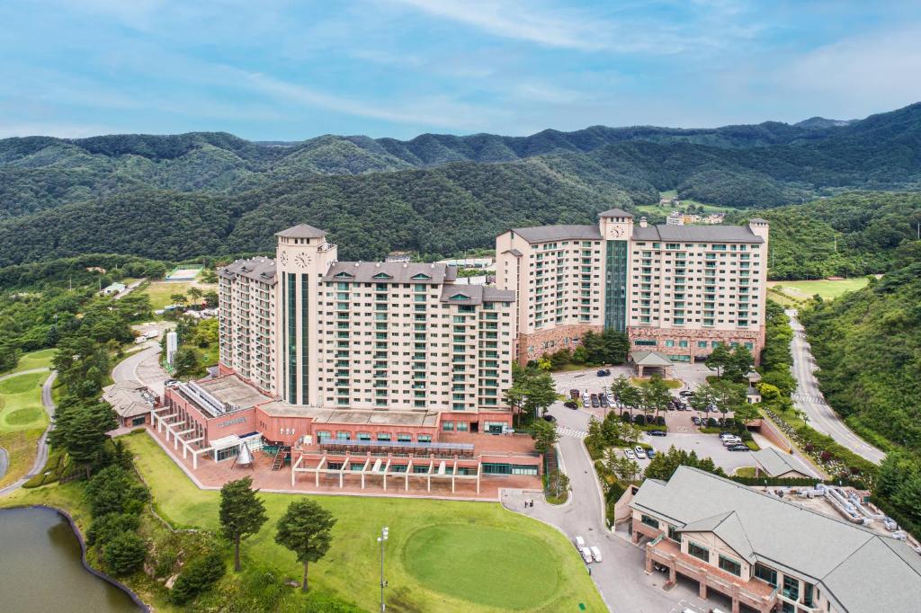 an aerial view of a resort with mountains in the background at OakValley Resort Hills Village in Wonju